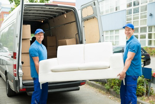 Removal team planning a flat move in Sutton with boxes and furniture