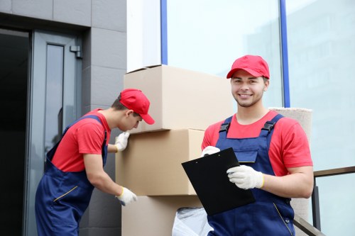 Man and van team loading furniture for a local move in Sutton