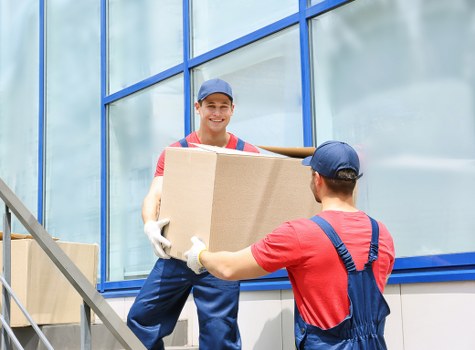 Piano removal team preparing an upright piano move in Sutton