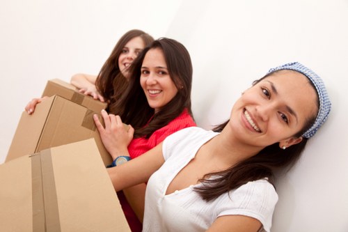 Local movers carrying furniture through a flat staircase in Sutton