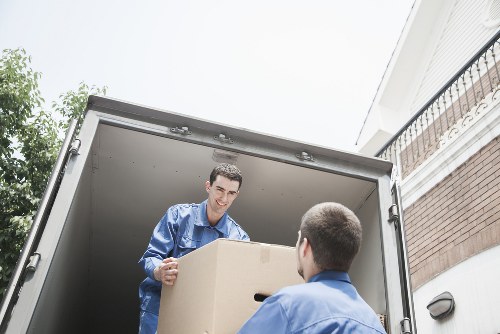 Removal crew handling furniture in a Sutton apartment building